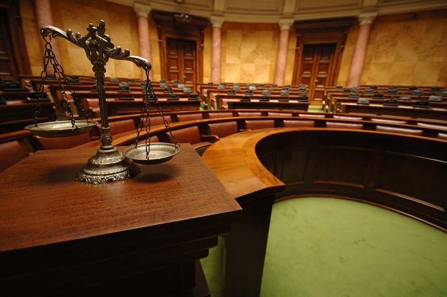 empty courtroom with the scales of justice